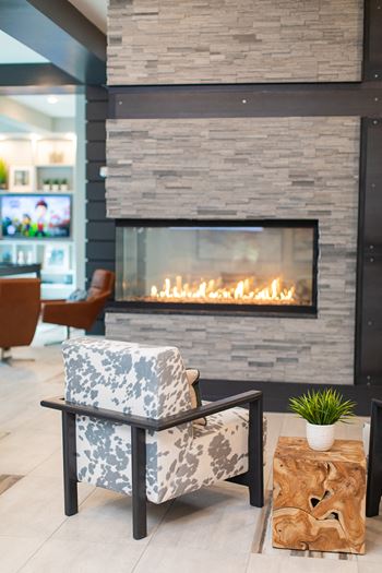 A chair in front of a fireplace